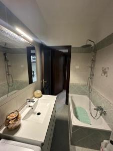 a bathroom with a sink and a tub and a shower at La casa di Giulietta in Rome