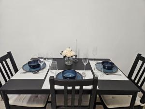 a black table with chairs and plates and wine glasses at Old city life in Maribor