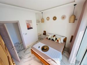 a bedroom with a large bed and a mirror at BATUU Luxury Living SEA FRONT in Bizerte