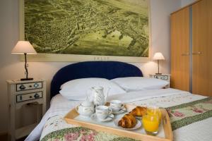 a tray of food on a bed with a tray of pastries at Apartment See Everlasting Split in Split