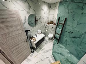 a bathroom with a sink and a marble wall at BATUU Luxury Living SEA FRONT in Bizerte +132 photos