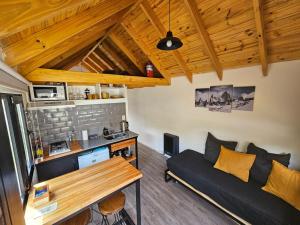 a living room with a couch and a table at Patagonia Tiny House in El Chalten