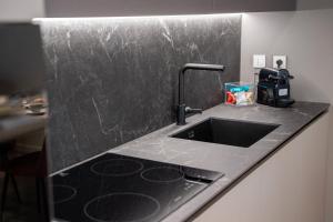 une cuisine avec un évier et un plan de travail dans l'établissement N-149 Luxury Apartments, à Bari