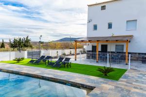 a villa with a swimming pool and a house at Casa Cristea Barranda in Caravaca de la Cruz