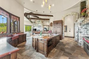 a large kitchen with a large island in a room at Deer Valley Luxury Home in Gated Community, Private Hot Tub, Amazing Views, Gourmet Kitchen in Heber City