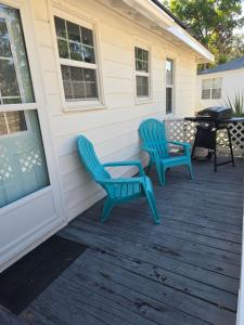two blue chairs and a table on a porch at Charming 3-bedroom home in beautiful Panama City in Panama City