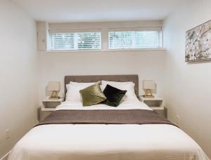 a bedroom with a large bed with two windows at Swallow's Perch Guest Suite in Vesuvius