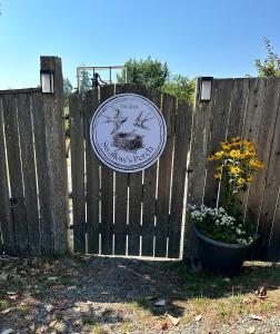 a wooden fence with a sign on it at Swallow's Perch Guest Suite in Vesuvius