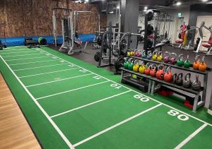 a gym with a tennis court and some weights at Birmingham City Centre apartment broad street in Birmingham