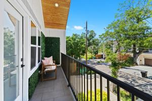 a balcony of a house with a chair at Downtown Luxe Retreat - King Bed, Pool, Pong, Billiards, Grill & FREE Coffee in Houston