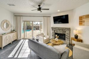 a living room with a couch and a fireplace at half Mi to Frisco Commons Park Poolside Oasis! in Frisco