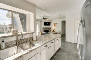 a kitchen with white cabinets and a sink and a window at half Mi to Frisco Commons Park Poolside Oasis! in Frisco