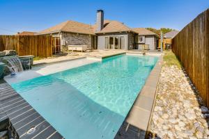 a swimming pool in the backyard of a house at half Mi to Frisco Commons Park Poolside Oasis! in Frisco