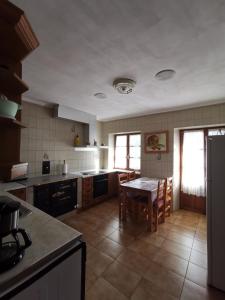 a kitchen with a table and chairs in it at GURE TXOKO Casa Rural in Odériz