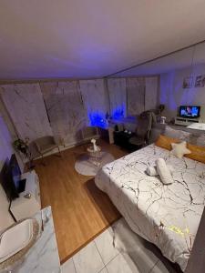 a bedroom with a bed in a room with blue lights at Nid Dor avec Parking in Carquefou