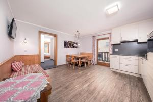 a room with a kitchen and a dining room at das Huber in Mayrhofen