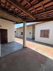 an empty patio with a wooden roof on a building at Casa na praia do Guaiuba in Guarujá +11 photos