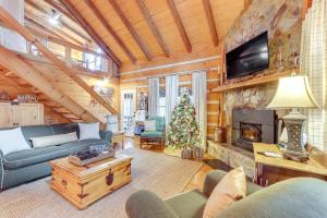 a living room with a christmas tree in a cabin at Hot Tub and Games Ridgetop Cabin in Blue Ridge! in Blue Ridge