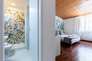 a bedroom with a bed and a bathroom at Fantastic Rome Guest House in Rome
