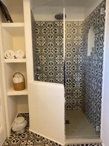 a walk in shower with a glass door in a bathroom at La Baia di Napoli in Capri