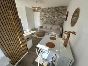 a living room with a table and a couch at MarbleMood Spa in Obernai