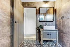 a bathroom with a sink and a mirror at La Loft - Modern Living in Mudgee Town Center in Mudgee +62 photos