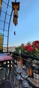 a table with wine glasses and a bottle on a balcony at Wonderful heart of Nice in Nice
