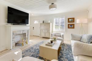 a living room with a couch and a fireplace at Walk Downtown and Canton Street Roswell Retreat! in Roswell