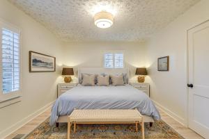 a white bedroom with a bed and a window at Walk Downtown and Canton Street Roswell Retreat! in Roswell