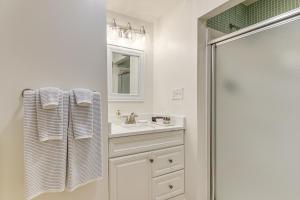 a white bathroom with a sink and a shower at Walk Downtown and Canton Street Roswell Retreat! in Roswell +17 photos