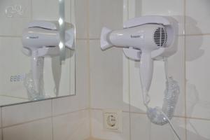 a blow dryer and a phone in a bathroom at GQ Deluxe Apartment in Saarbrücken
