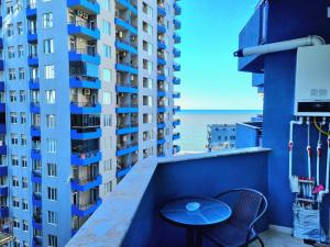 a table on a balcony with a view of the ocean at Sea apartment baTumi in Batumi