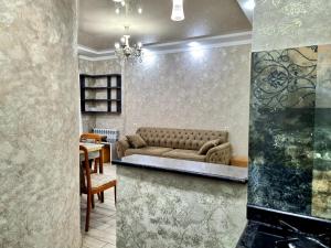 a living room with a couch and a table at Sea apartment baTumi in Batumi