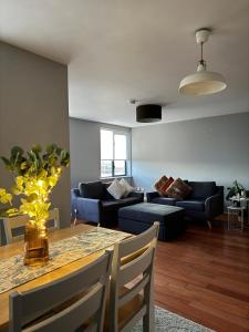 a living room with a table and a couch at Dublin Private Room in Dublin