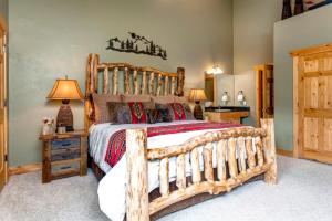 a bedroom with a large wooden bed in a room at KBM Resorts Timber Wolf Lodge Walk to Canyons Cabriolet Fireplace BBQ Aspens Creek Parking TWL-12c in Park City
