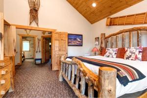 a bedroom with a large bed with a wooden frame at KBM Resorts Timber Wolf Lodge Mountain Elegance with Gas Fireplace Common Hot Tubs Near Canyons Village TWL-5b in Park City
