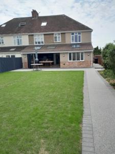 a house with a lawn in front of it at The Henge House in Salisbury