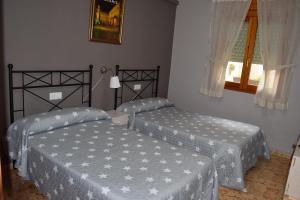 A bed or beds in a room at Casa Rural Javier