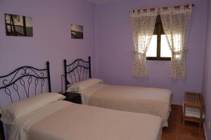 A bed or beds in a room at Casa Rural Javier