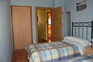 A bed or beds in a room at Casa Rural Javier