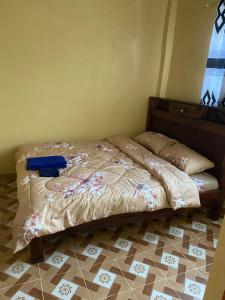 Postel nebo postele na pokoji v ubytování Tsavo Apartments Ogembo