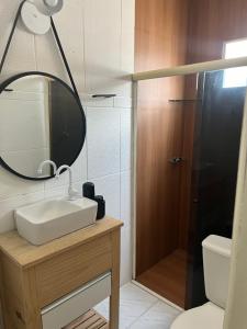 a bathroom with a sink and a mirror at Chalé Park Mar II Casa c piscina,São José,Maragogi in São José da Coroa Grande +11 photos
