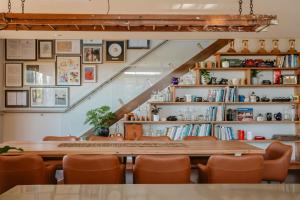 a table and chairs in a room with bookshelves at La Vista Janoora in Flinders