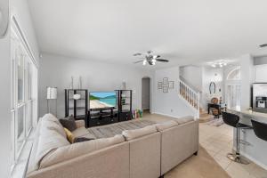 a living room with a couch and a table at 12 Min to Disney Heated Pool Family-Friendly BBQ Game Room & Sleeps 16 Guests in Davenport