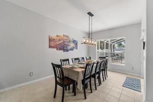 a dining room with a table and chairs at 12 Min to Disney Heated Pool Family-Friendly BBQ Game Room & Sleeps 16 Guests in Davenport