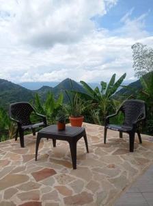 two chairs and a table on a patio with a view at Polandia in Villa Silvia