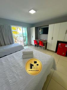 a hotel room with a bed with a sign on it at Melhores Flats - Maravilhosa varanda frente ao mar in João Pessoa