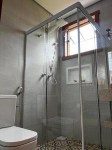 a bathroom with a shower and a toilet at Serra Vale D l 2 Suítes l Centro Histórico l Garagem in Tiradentes +17 photos
