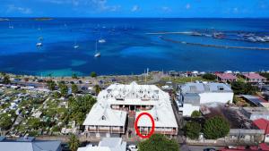 a building with a red circle on it next to the water at 2 bedroom Caribbean charm in Marigot's heart in Marigot