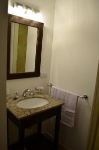 a bathroom with a sink and a mirror at Majuto in San Carlos de Bariloche +3 photos